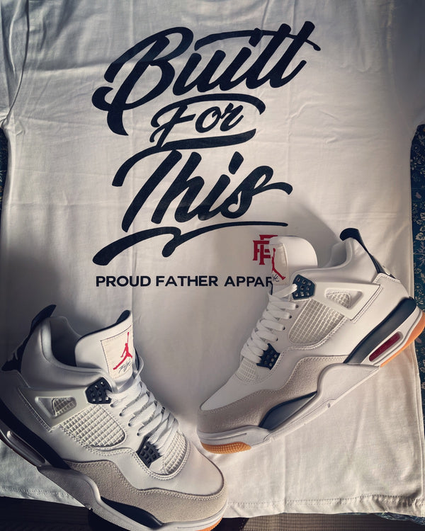 Pair of white sneakers with black accents on a shirt with 'Built For This' text.
