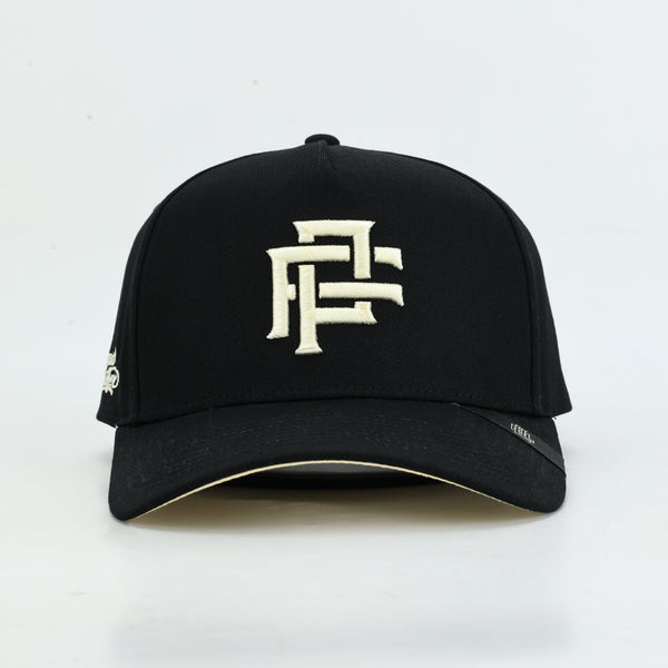 A black baseball cap with a prominent white embroidered geometric logo on the front, photographed against a clean white background.